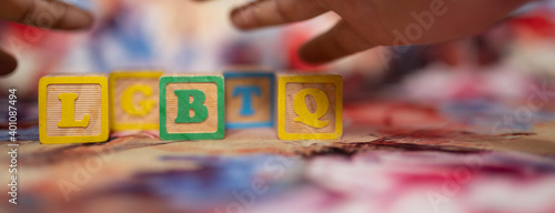 alphabetical letters placed on colored wooden cubes forming the word LGBTQ