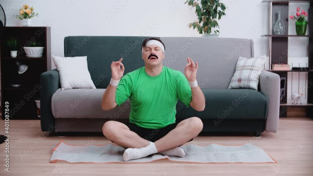 Man in lotus position doing a special finger position while taking a deep breath, getting ready for indoor yoga meditation. Man in lotus position doing a special finger position while taking a deep breath, getting ready for indoor yoga meditation.