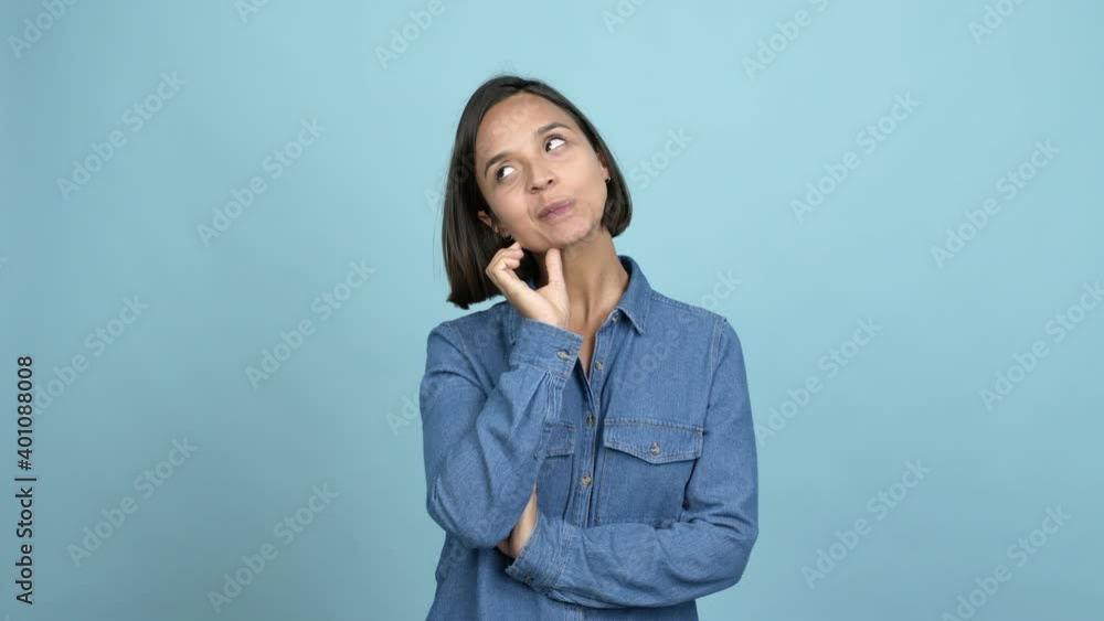 Young latin woman having doubts and questioning an idea over isolated background Young latin woman having doubts and questioning an idea over isolated background