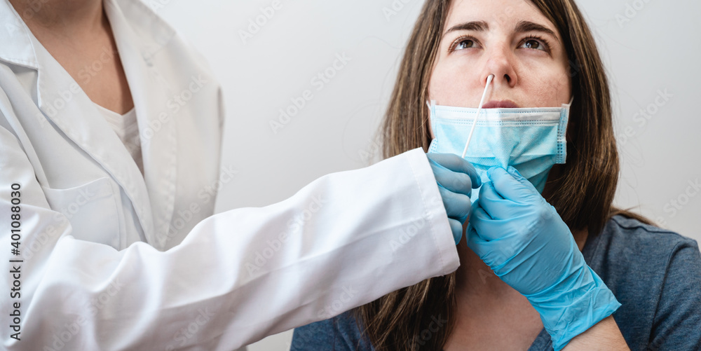 Doctor nurse worker taking nasal swab test for possible coronavirus infection - Focus in nose Doctor nurse worker taking nasal swab test for possible coronavirus infection - Focus in nose