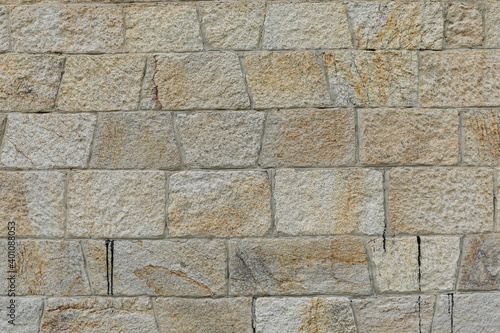 New  and even brick wall with structure of white  grey and brown stones  stones background with space for text