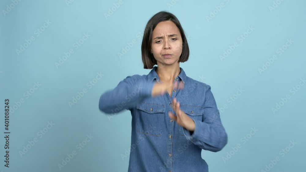 Young latin woman doing time out gesture over isolated background Young latin woman doing time out gesture over isolated background