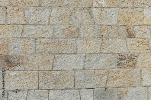 Beautiful new stone wall with structure of bright bricks, stones background empty with space for text