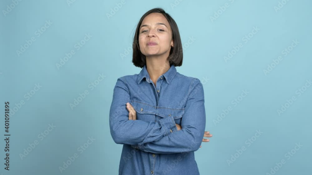 Young latin woman standing and looking to the side over isolated background