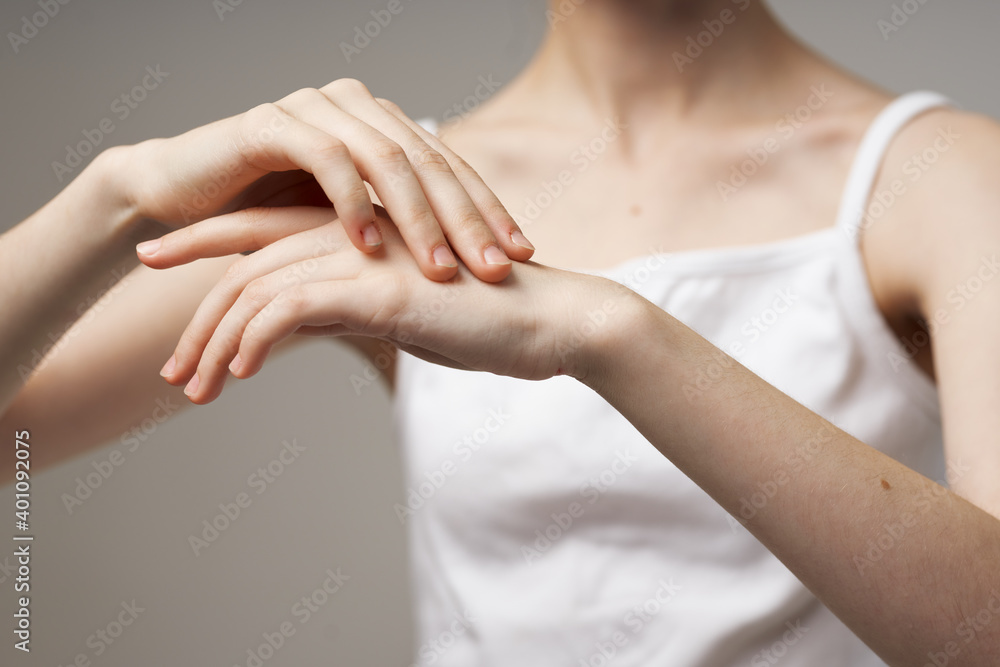 slender woman touching her hands on beige background cropped view