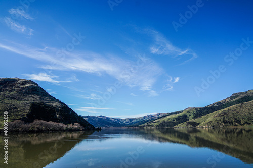 A Peaceful, Reflective Lake Sits Quietly © imagesbynunez
