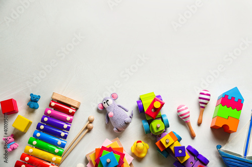 Different toys on light background, flat lay. Space for text