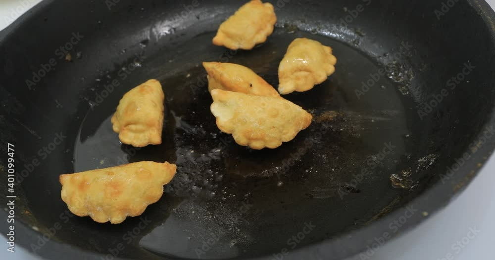 Girl roasts food in a frying pan Girl roasts food in a frying pan