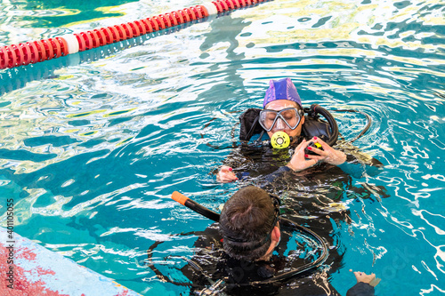 pair of divers in the water planning an activity