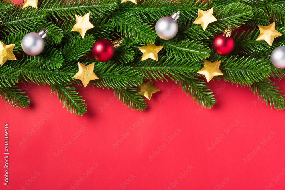 Christmas background presents greeting card with top view overhead green fir tree branches and decoration, Xmas holiday celebration season on red table background with copy space