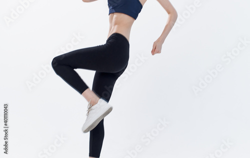 energetic woman on light background jumping in sportswear Copy Space Fitnes