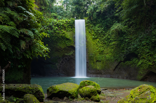 Waterfall landscape. Beautiful hidden waterfall in tropical rainforest. Nature background. Slow shutter speed, motion photography. Tibumana waterfall, Bali, Indonesia