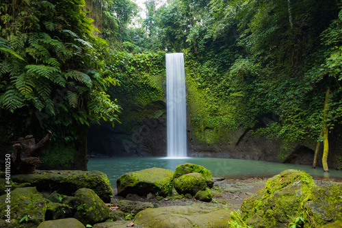 Waterfall landscape. Beautiful hidden waterfall in tropical rainforest. Nature background. Slow shutter speed, motion photography. Tibumana waterfall, Bali, Indonesia