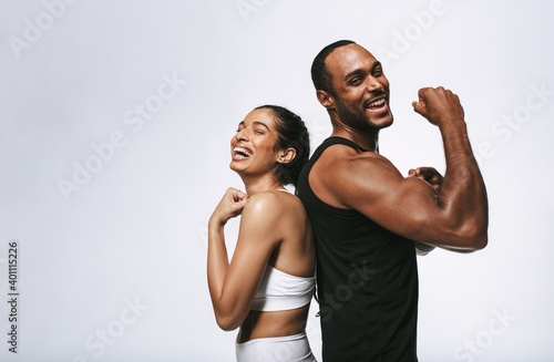 Cheerful fit couple on white background photo