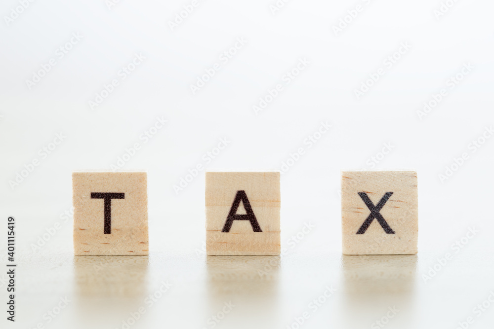 wooden block with word tax, pay and debt, business and finance concept. wooden block with word tax, pay and debt, business and finance concept.