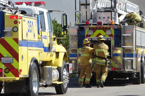 Фотография Firemen responding to fire emergency accident to help with fire engines trucks a