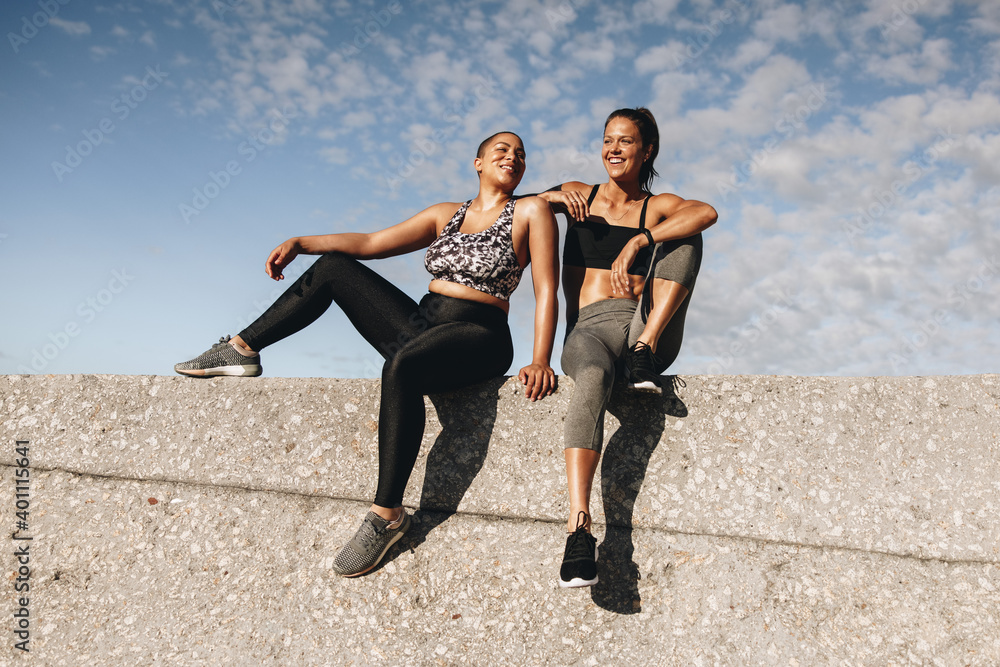 Fitness women relaxing after training session Fitness women relaxing after training session