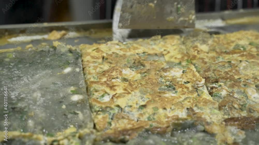 Cooking And Flipping Oyster Omelette In A Griddle Pan - extreme close up Cooking And Flipping Oyster Omelette In A Griddle Pan - extreme close up