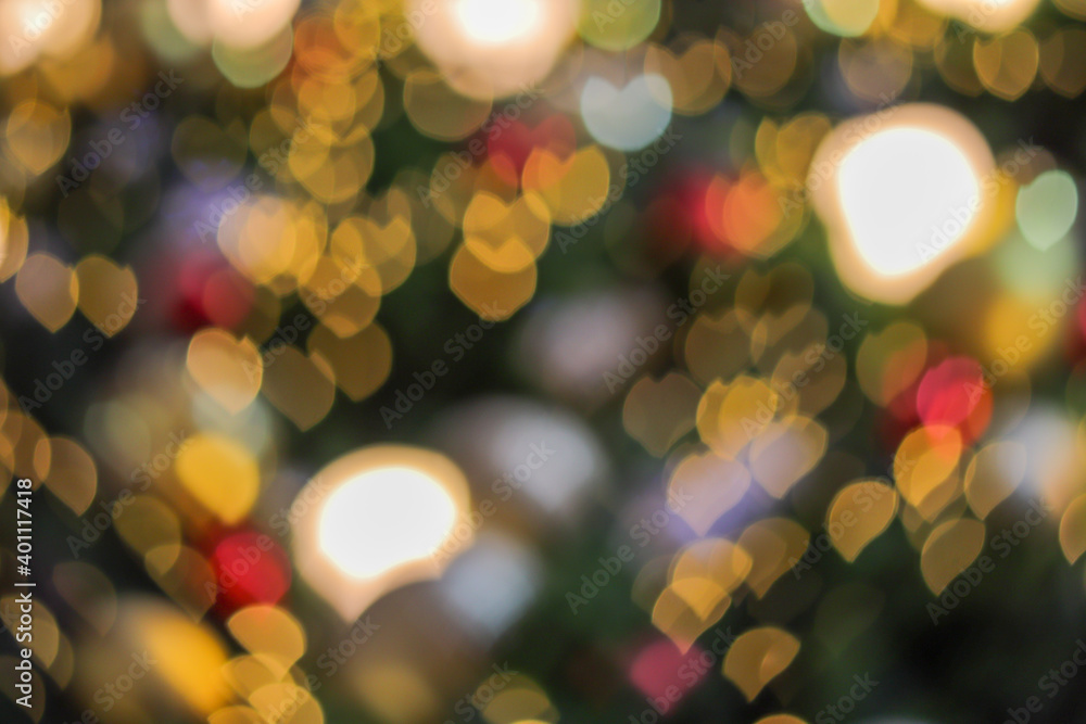 Fototapeta premium Blurred bokeh background created by the Christmas lights to celebrate the New Year. Beautiful Christmas lights backgrounds and backdrop can be used for any design Or a Christmas greeting card.