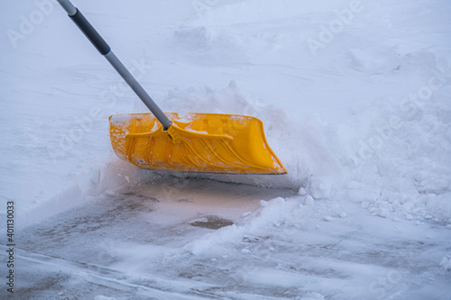 Clearing snow from driveway after heavy winter storm