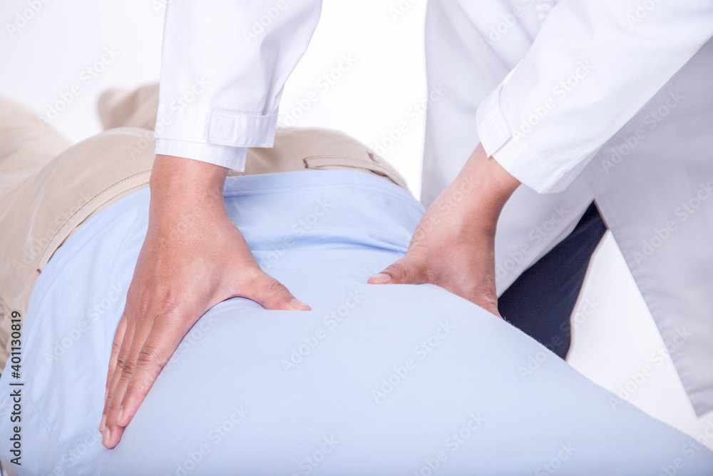 Fototapeta premium Doctor physiotherapist doing healing treatment on man's back. Physiotherapist working concept