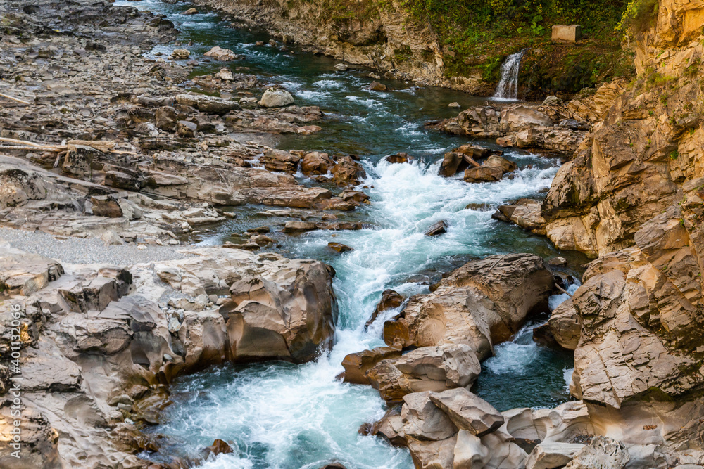 Landscape with a mountain river flowing through canyon