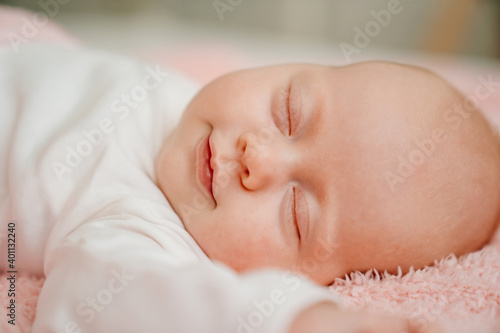 sleeping baby under the pink blanket. healthy sleep in newborns.