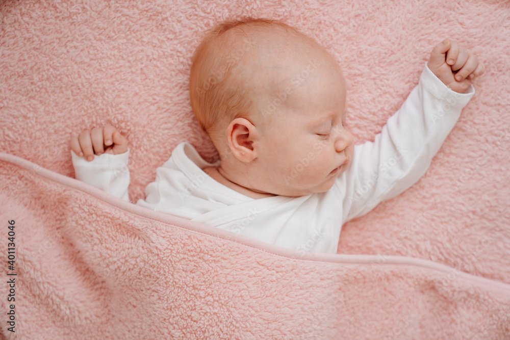 sleeping baby under the pink blanket. healthy sleep in newborns. sleeping baby under the pink blanket. healthy sleep in newborns.