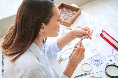 Female jewelry designer working in office, closeup