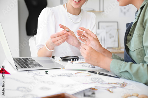 Female jewelry designers with adornment in office