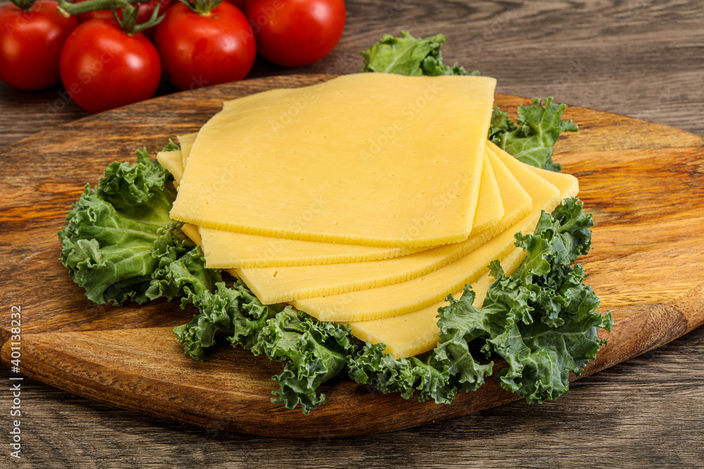 Sliced Gauda cheese over board Sliced Gauda cheese over board