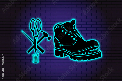 Shoe repair service. Neon symbol in old retro style. On background of brick illuminated wall