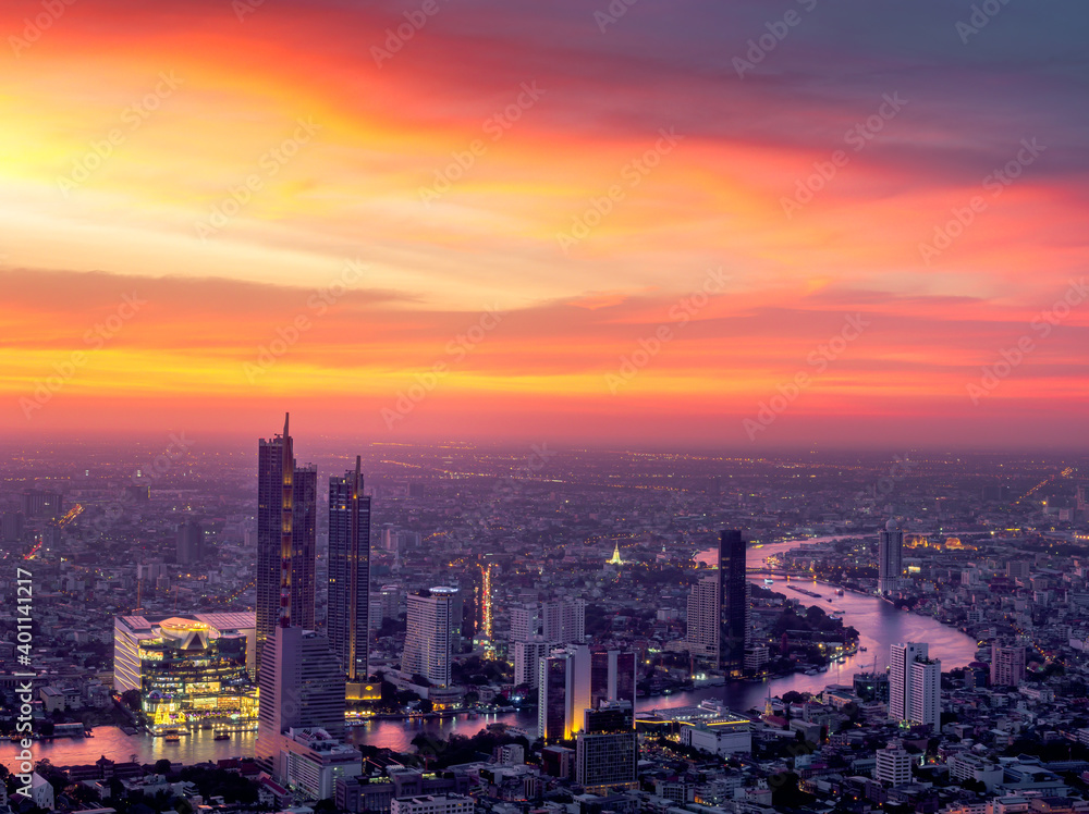 Aerial view of Bangkok skyscraper with orange sky sunset. Citysapce and Chao Phraya River in Thailand Capital