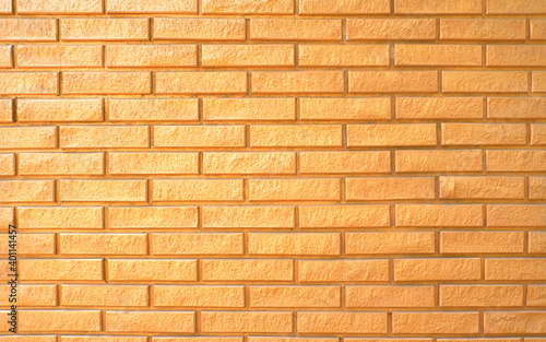 Gold brick wall texture for decoration. Luxurious surface background.