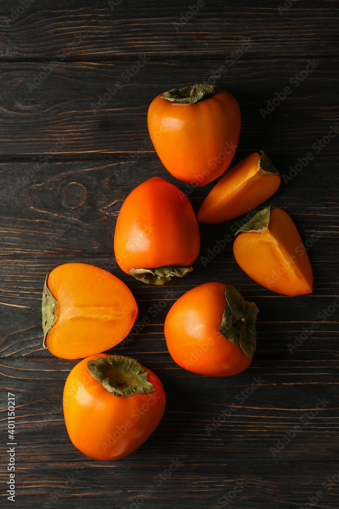 Fresh ripe persimmon on wooden background, top view Fresh ripe persimmon on wooden background, top view