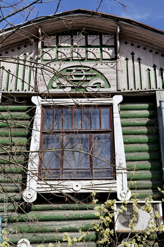Ornamental carved window, frame on old wooden Balmasov's house in Okruzhnaya Street, 51, Rostov Veliky, Yaroslavl region, Russia. Art nouveau style in Rostov architecture photo