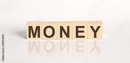 MONEY word from wooden blocks on the white desk