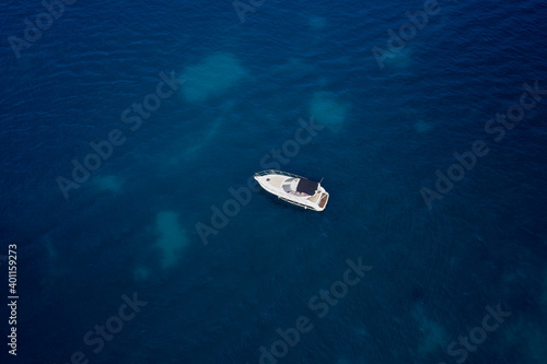 White, large yacht, mooring on blue water, aerial view of the yacht