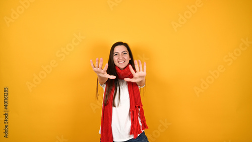 Girl with a red scarf on a yellow background © SYARGEENKA