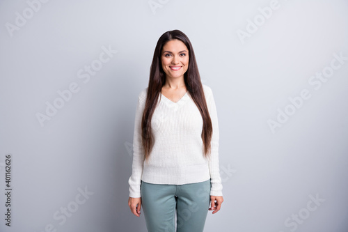 Photo of mature positive smiling cheerful good looking woman with long brown hair isolated on grey color background
