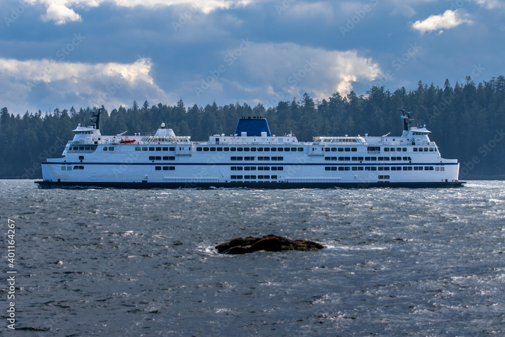 BC Ferry travels past an island.
