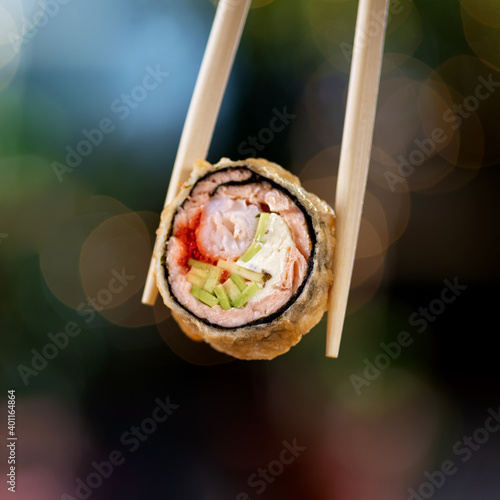 Hot fried sushi roll with salmon and wine. Sushi menu. Japanese food. Hot fried sushi roll