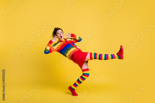 Profile photo of shocked lady felling down slippery floor wear striped sweater short skirt knee socks shoes isolated yellow color background