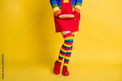 Cropped view of nice fashionable girl posing wearing cosy garment isolated over bright yellow color background