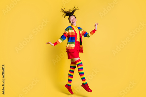 Full length body size view of careless funky glad girlish cheerful wavy-haired girl jumping isolated bright yellow color background