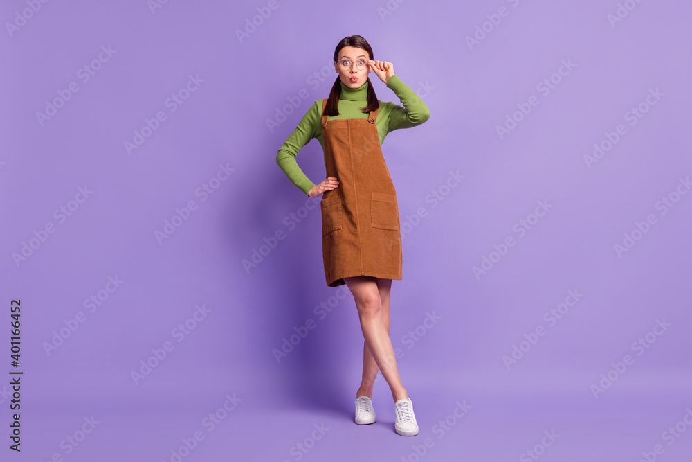 Full length body size view of pretty comic cheerful girl touching specs pout lips isolated over violet pastel color background Full length body size view of pretty comic cheerful girl touching specs pout lips isolated over violet pastel color background