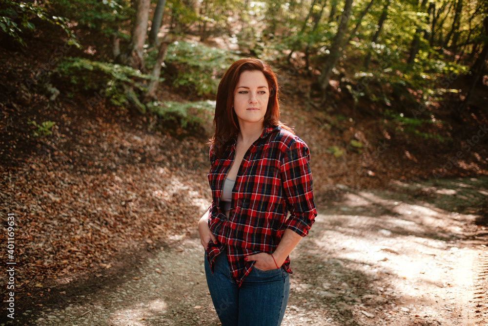 traveler hipster woman standing alone in autumn woods . traveler hipster woman standing alone in autumn woods .