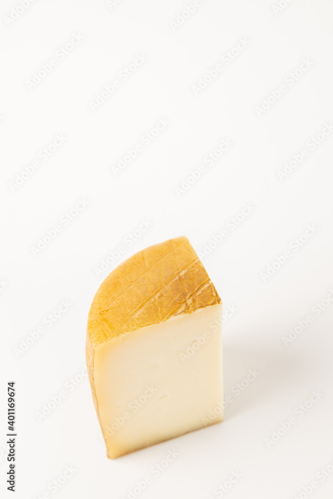 wedge of spanish cheese on white background