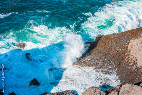 ocean waves crashing against the cliffs