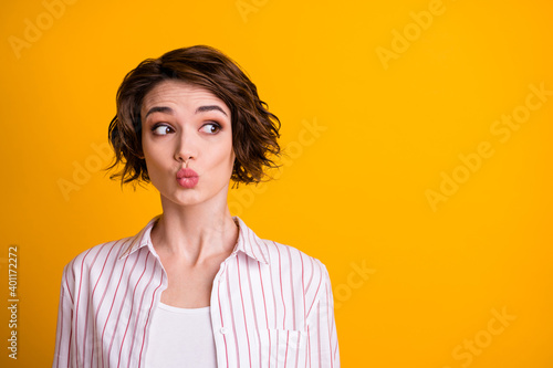 Photo of cute sweet nice lovely surprised girl with her lips pouted plump look copyspace interested novelty secret wear striped shirt outfit isolated over vivid color background © deagreez